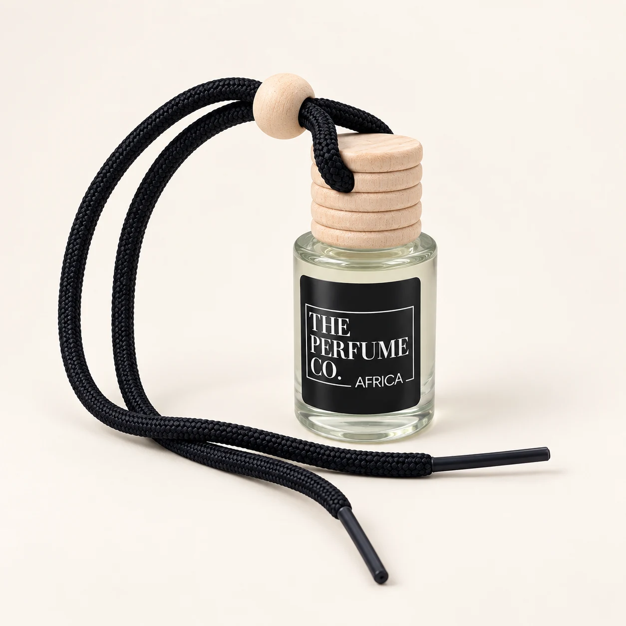 The Perfume Co. Africa car diffuser with wooden cap and black hanging cord; representative packaging for Bergamot & Tobacco.